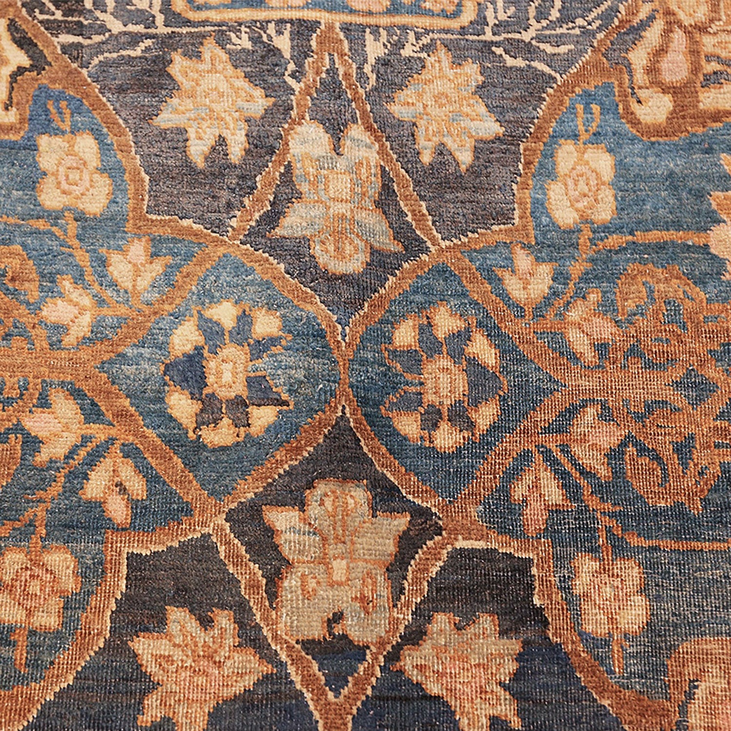Close-up of a vintage floral rug with intricate botanical motifs.