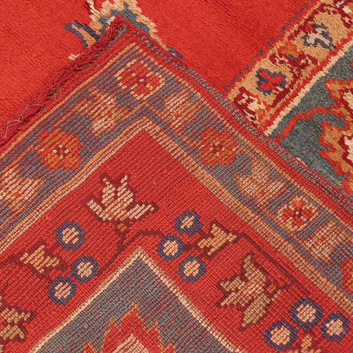 Close-up of a vibrant, handcrafted Oriental carpet with intricate designs.