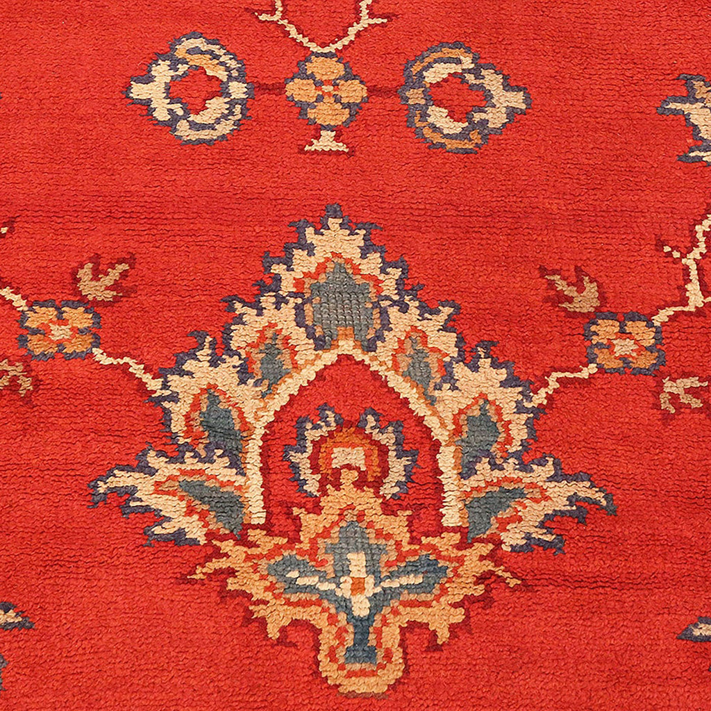 Vibrant red carpet with intricate traditional design showcases artisanship.