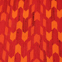 Close-up of plush, zigzag-patterned fabric in red and orange.