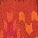 Close-up of warm, textured fabric with a handmade, autumnal pattern.