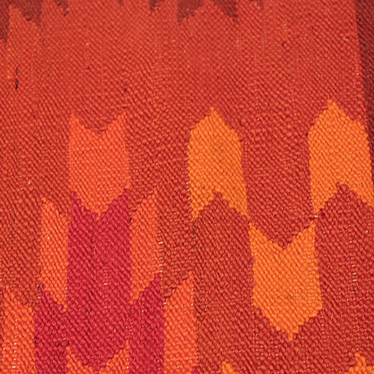 Close-up of warm, textured fabric with a handmade, autumnal pattern.