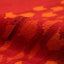 Close-up view of textured fabric in shades of red and orange.