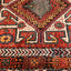 Intricate traditional rug showcases vibrant colors and geometric/floral motifs.