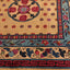 Ornate handcrafted carpet with floral motifs and interlocking geometric shapes.