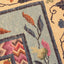 Close-up of a intricately woven textile with floral and geometric patterns.
