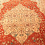 Intricately designed hand-woven rug with rich red background and floral motifs.