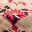 Close-up of a textured fabric with intricate red and black patterns.