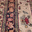 Close-up of vintage hand-knotted Oriental carpet with intricate design.