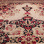 Intricately designed Oriental rug with traditional floral and geometric elements.