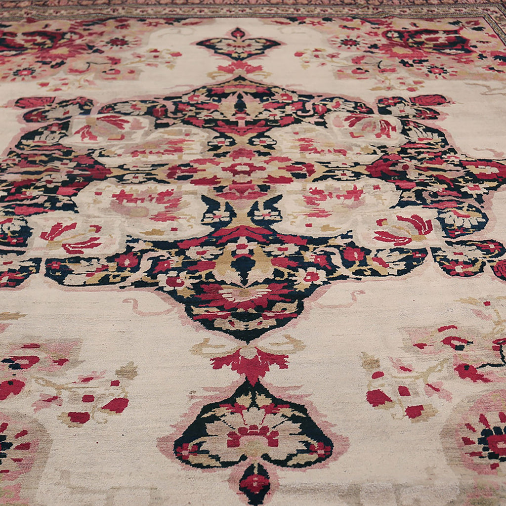 Intricate symmetrical carpet with floral and geometric motifs in rich colors.