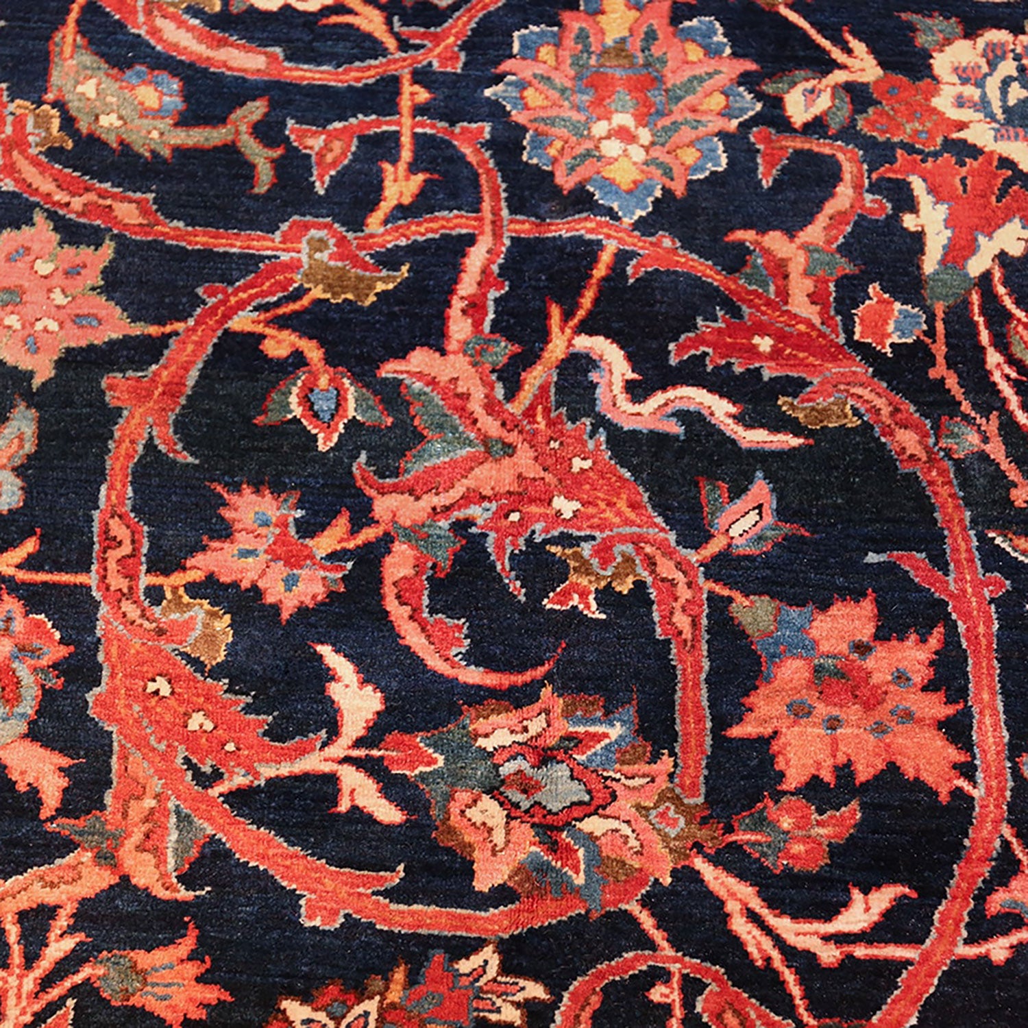 Intricate, vibrant floral design on a hand-woven, durable navy carpet.