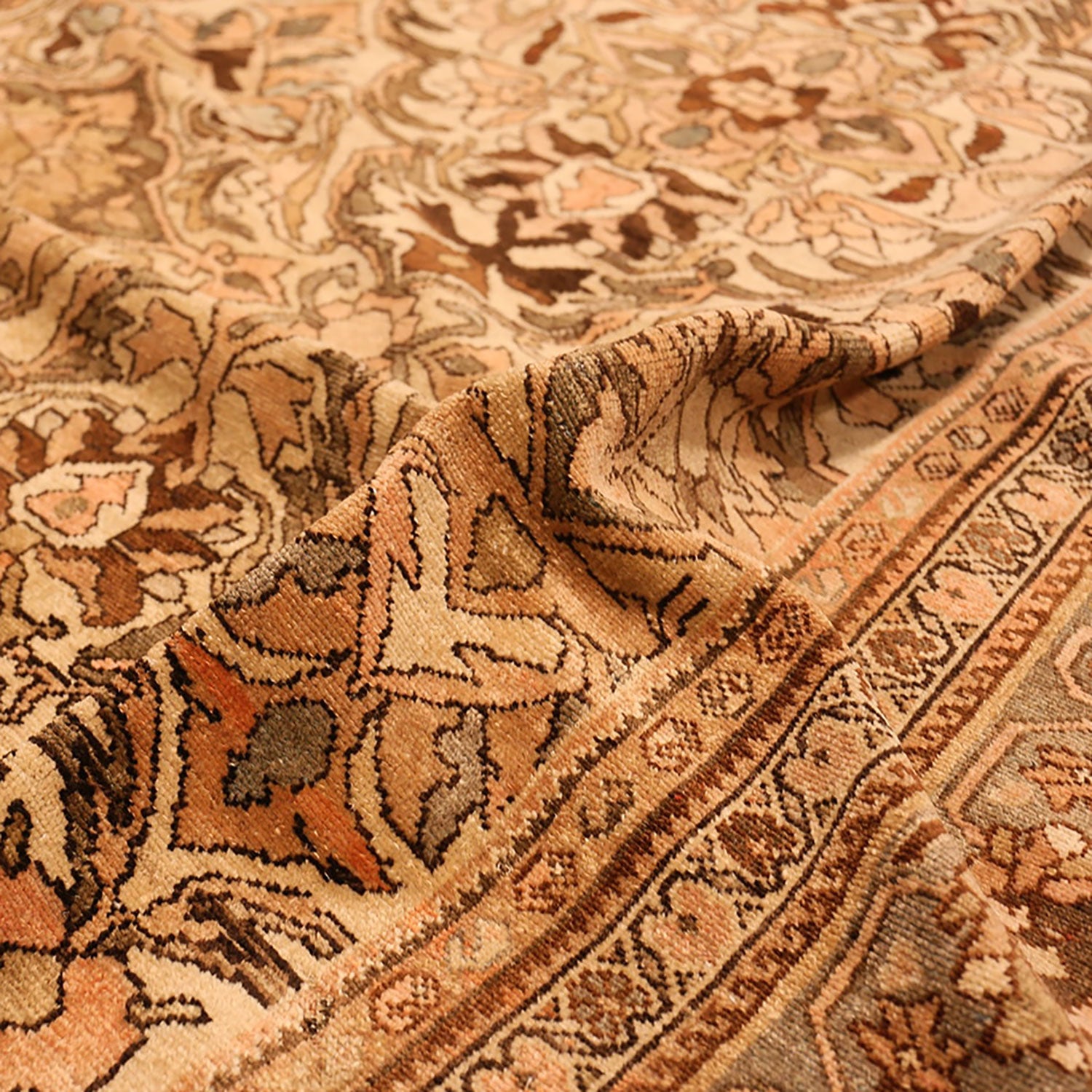 Close-up of an ornate Oriental rug with intricate floral patterns.