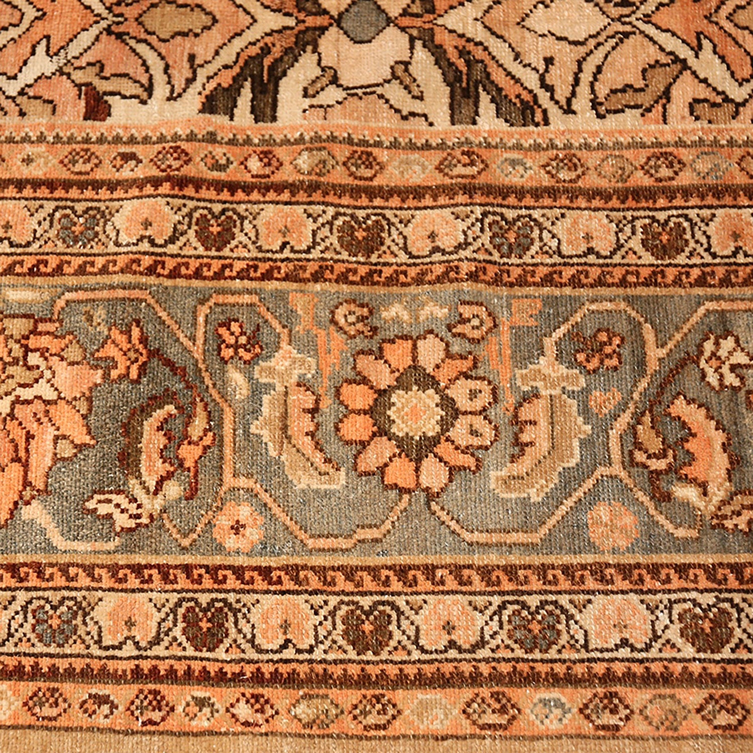 An intricately designed handwoven rug featuring traditional motifs and warm earthy tones.