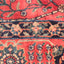 Close-up of intricate, colorful traditional rug with floral motifs.