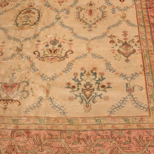 Close-up of an ornate, antique carpet with intricate floral designs