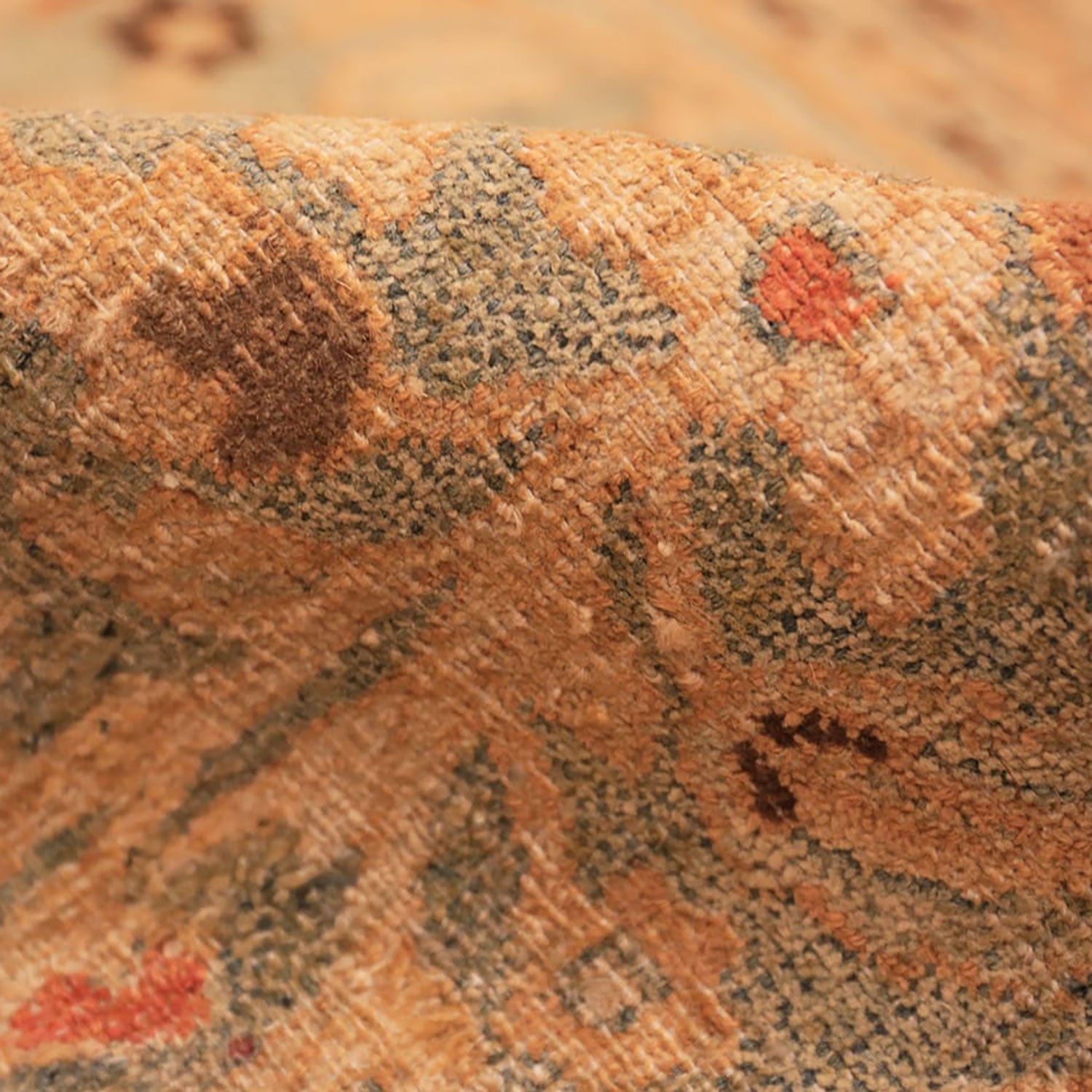Close-up of textured fabric with intricate pattern in earthy tones.