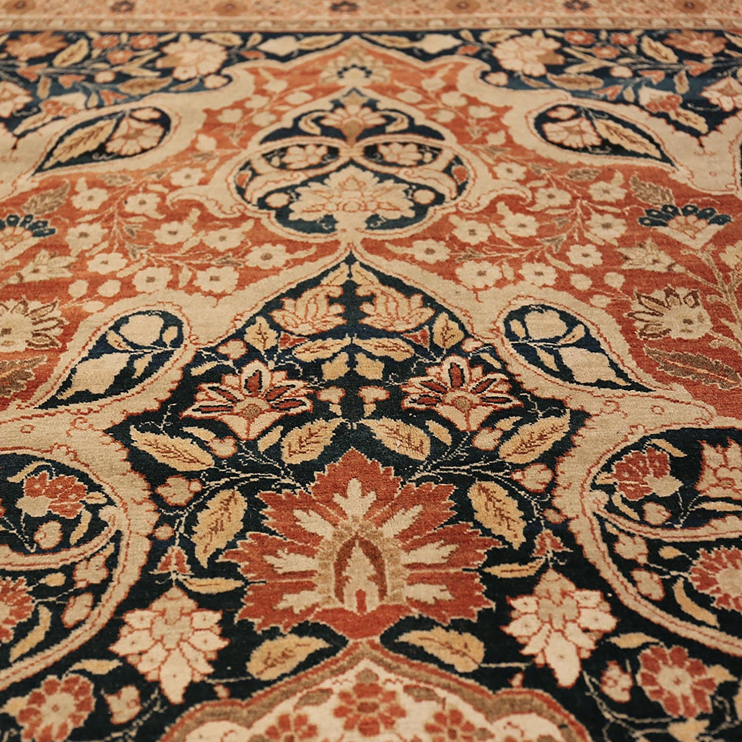 Close-up of a traditional ornate carpet in warm tones.