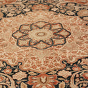 Close-up of an ornate, high-quality handcrafted carpet with floral patterns.