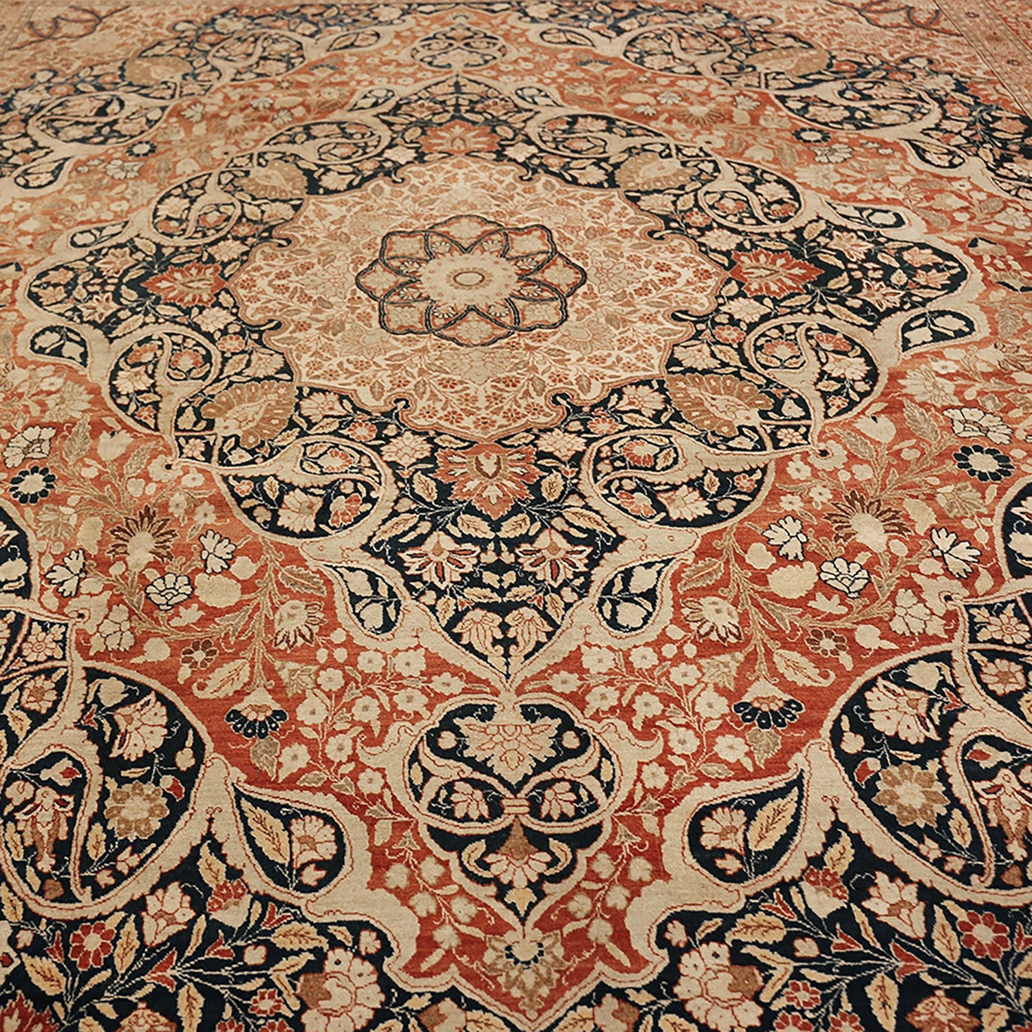 An intricately designed hand-knotted Persian carpet showcasing floral motifs.