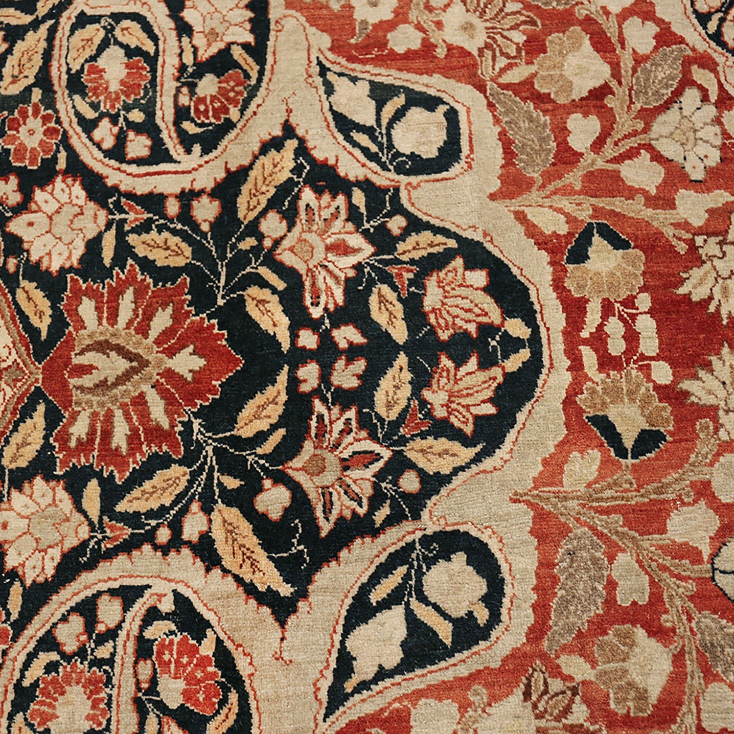 Intricate floral motifs adorn a high-quality, hand-knotted Persian carpet.