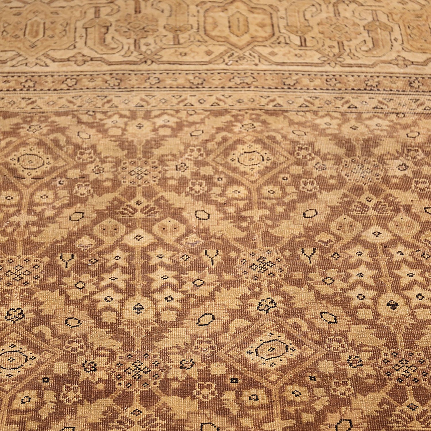 Intricate symmetrical rug design with earthy tones and geometric shapes.
