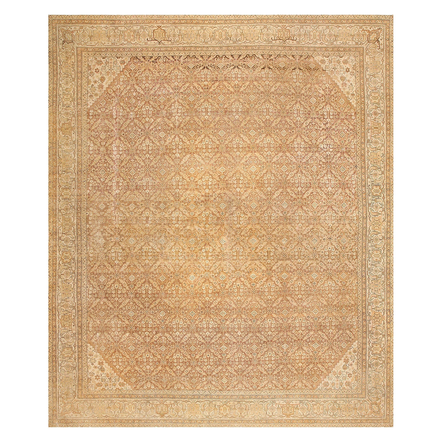 An intricately patterned, handmade rug showcases symmetrical diamond and floral motifs in muted tones.