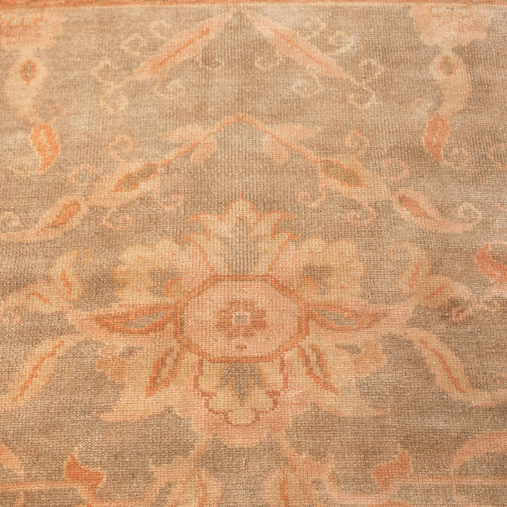 Intricate floral and leaf patterns adorn a woven beige carpet.
