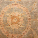 Close-up of a high-quality, symmetrical patterned fabric in shades of orange and beige.