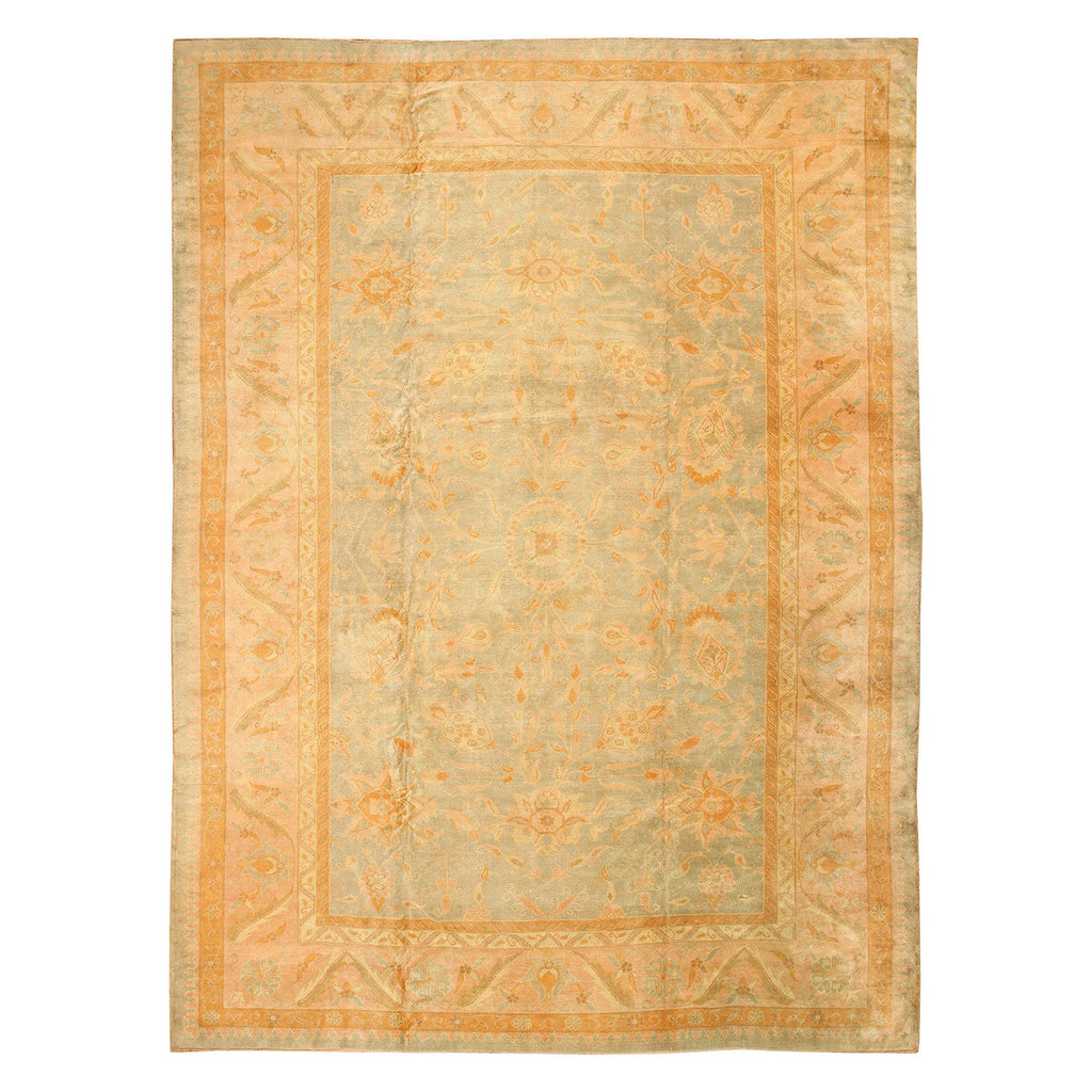 Faded vintage rug with intricate floral and geometric patterns.