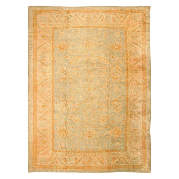 Faded vintage rug with intricate floral and geometric patterns.