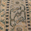 Close-up of a handwoven, ornate carpet with intricate geometric motifs.