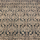 An intricate, traditional patterned carpet in neutral colors and dense layout.