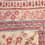 Intricate woven fabric showcases traditional motifs in vibrant colors.