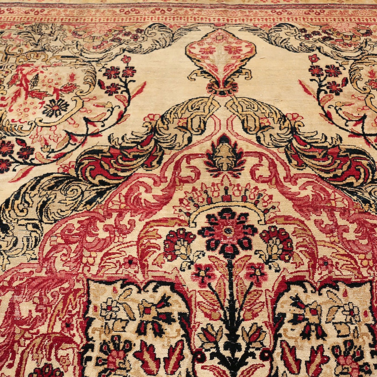 Close-up of a traditional rug with intricate floral motifs and vibrant colors.