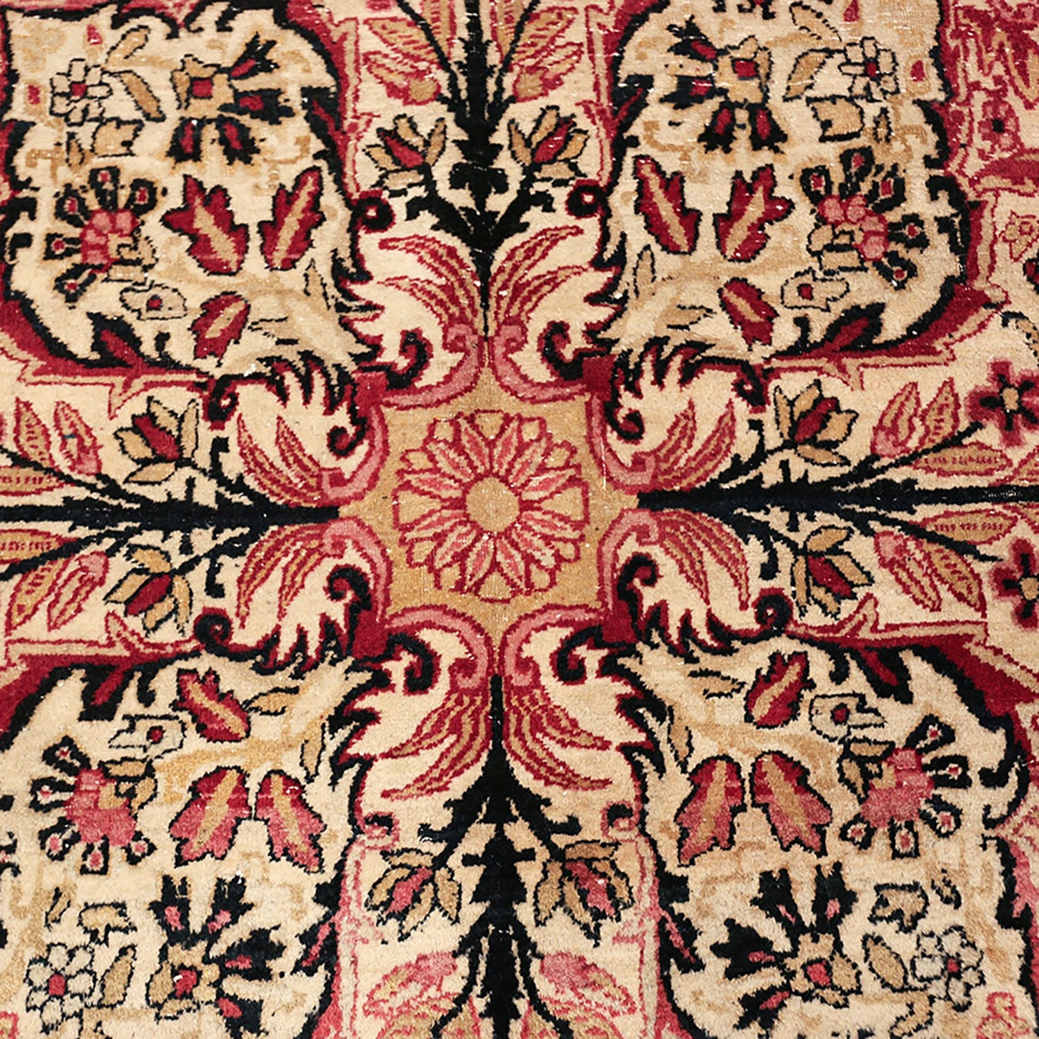 Intricate floral patterned carpet in shades of red and black.