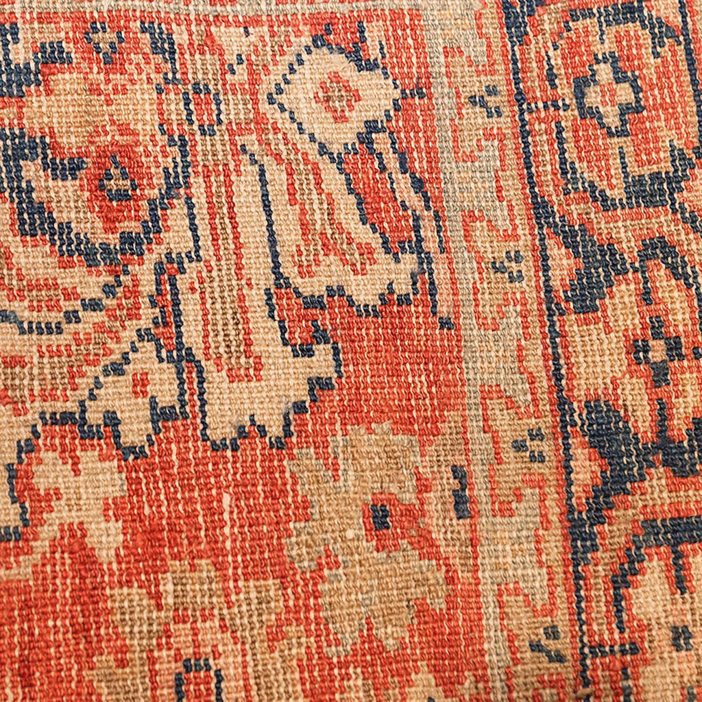Close-up of a handcrafted rug showcasing intricate floral and geometric motifs.