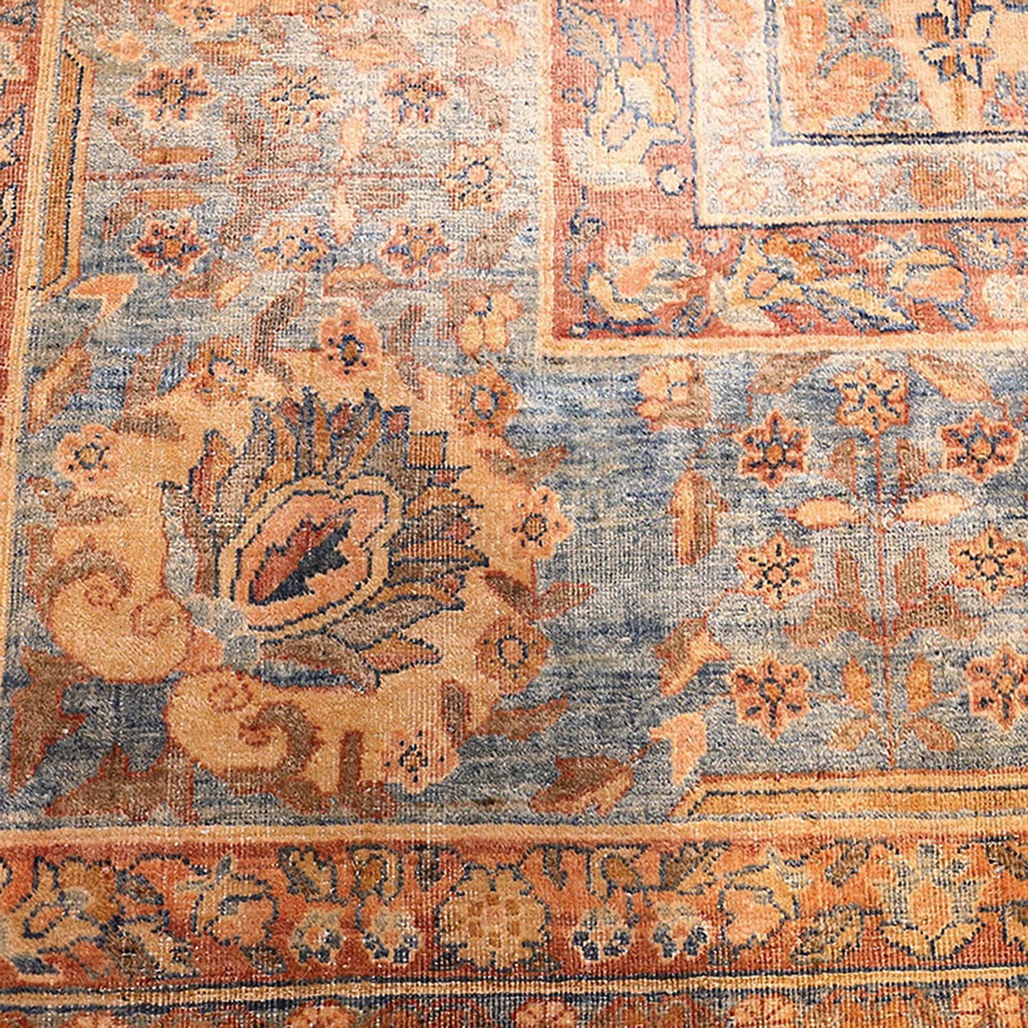 Ornate vintage carpet showcases intricate floral motifs in vibrant colors.