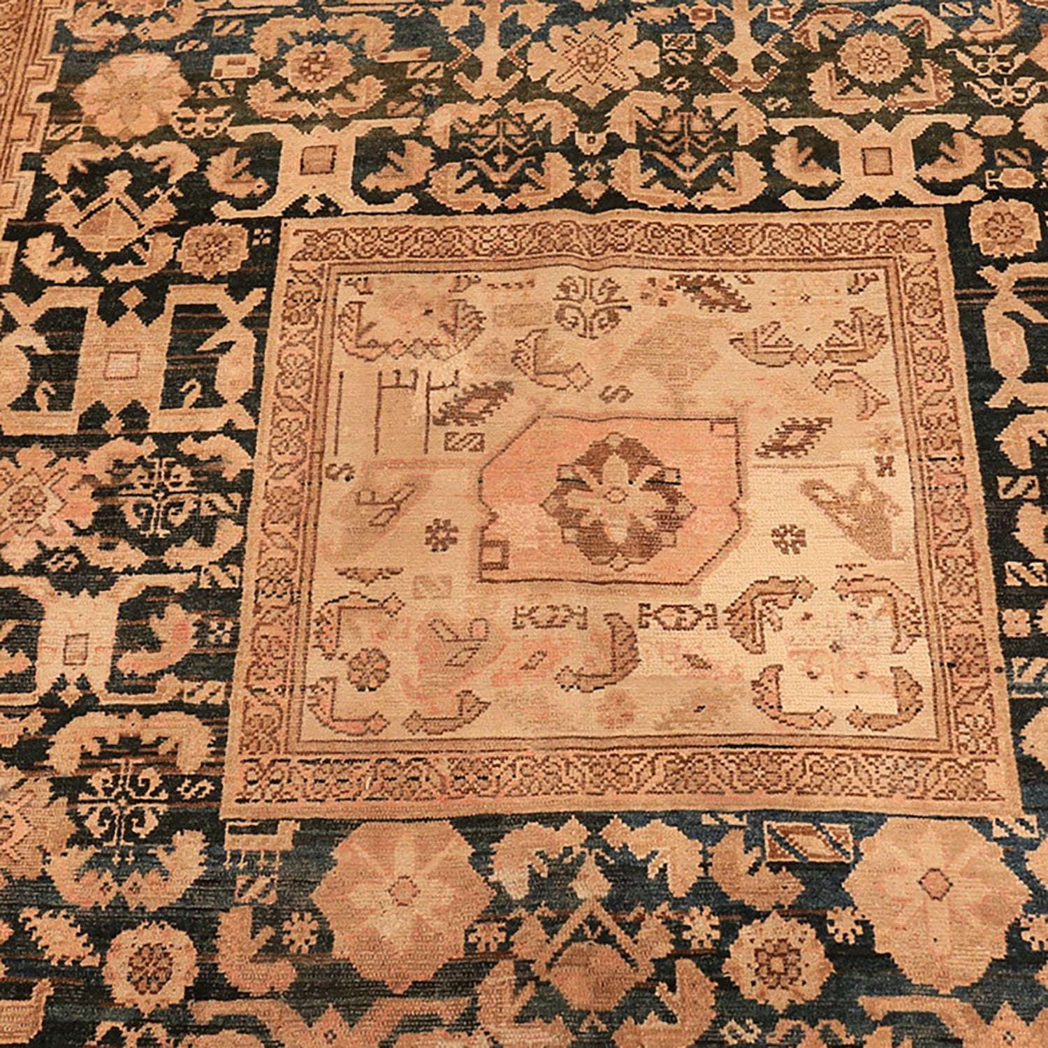 Ornate handwoven rug with intricate floral and geometric motifs