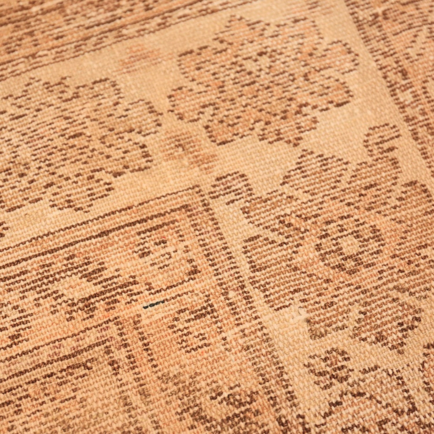 Close-up view of a intricately designed, neutral-colored, textile carpet pattern.