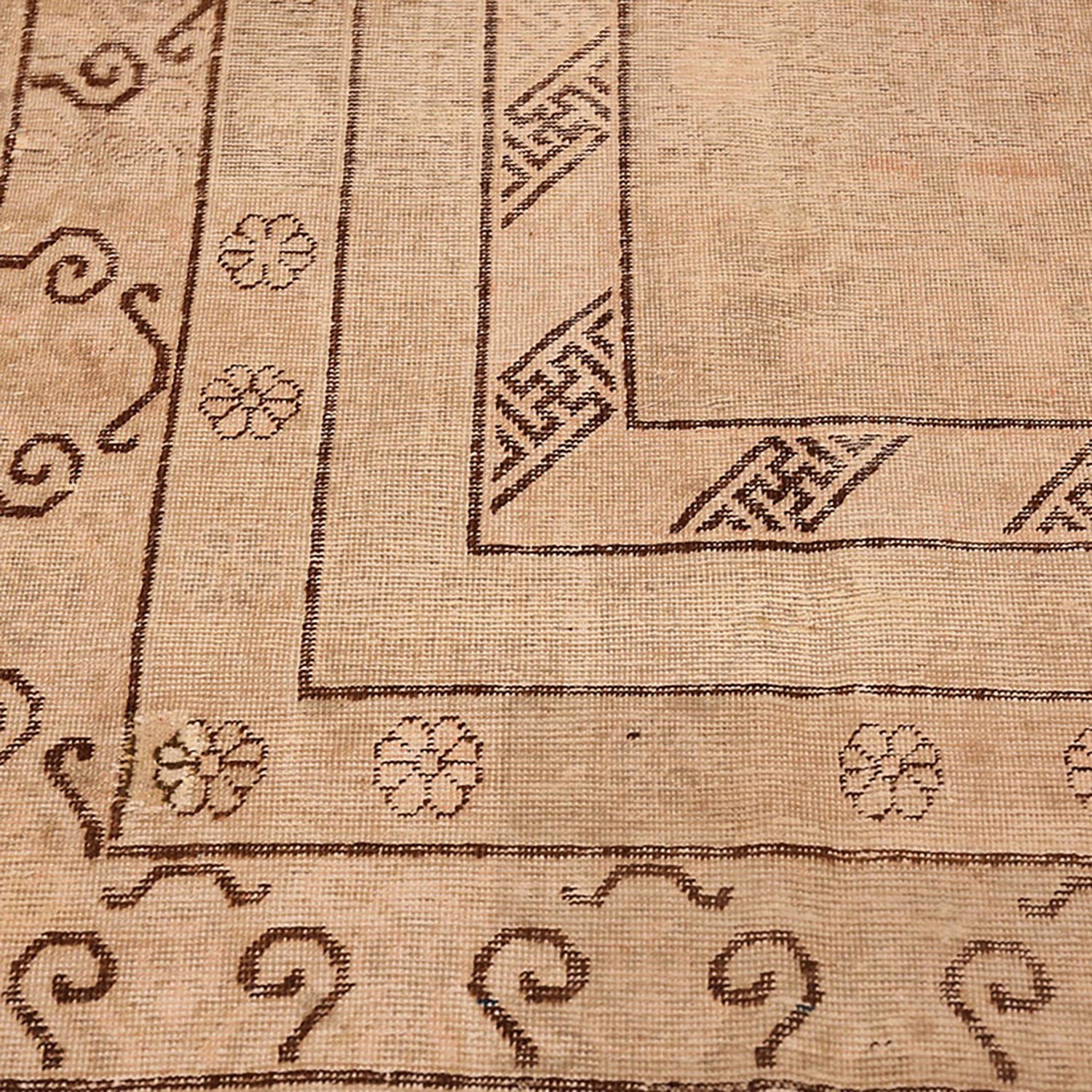 Detailed patterned carpet or rug with geometric borders and floral motifs.