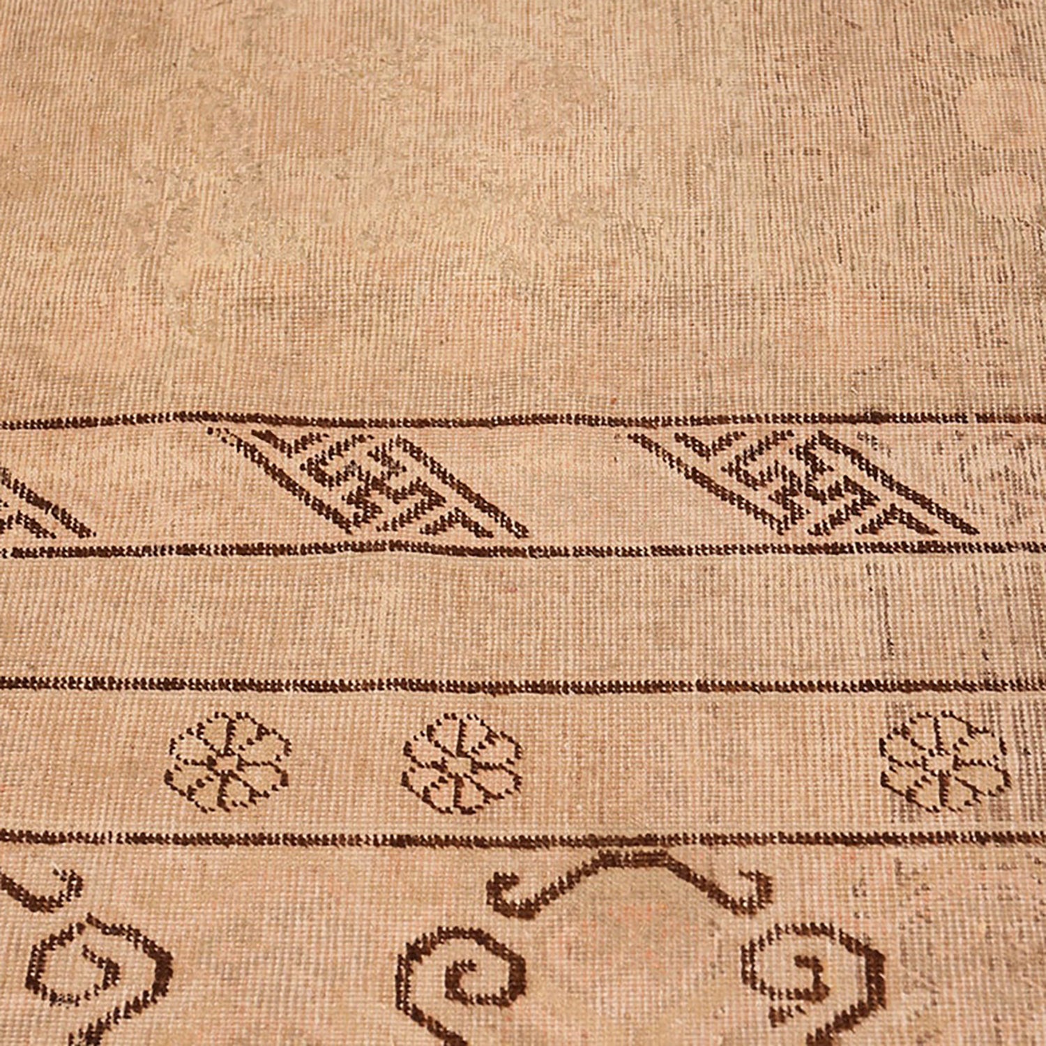 Traditional geometric patterns adorn a high-quality woven carpet with symmetry.