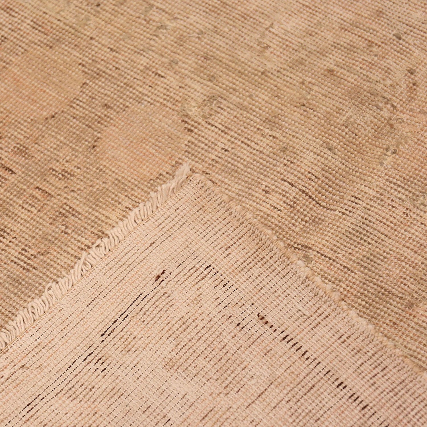Close-up view of a woven fabric with visible threads and imperfections.