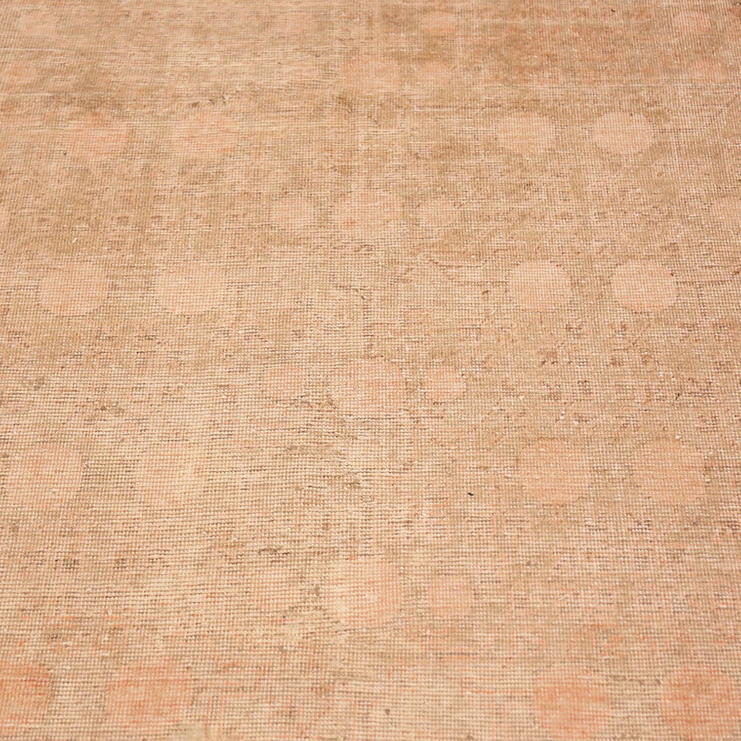 Close-up view of a beige textured surface with circular patterns.