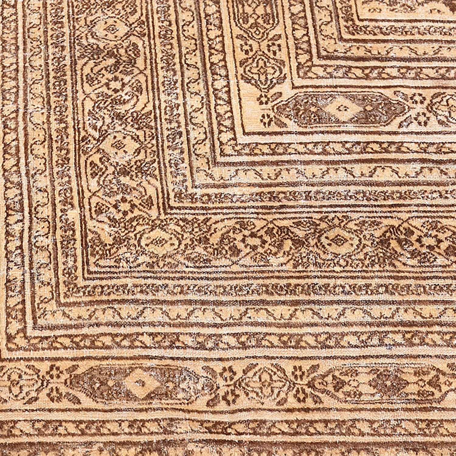 Close-up of a traditional patterned carpet with intricate details and earth tones.