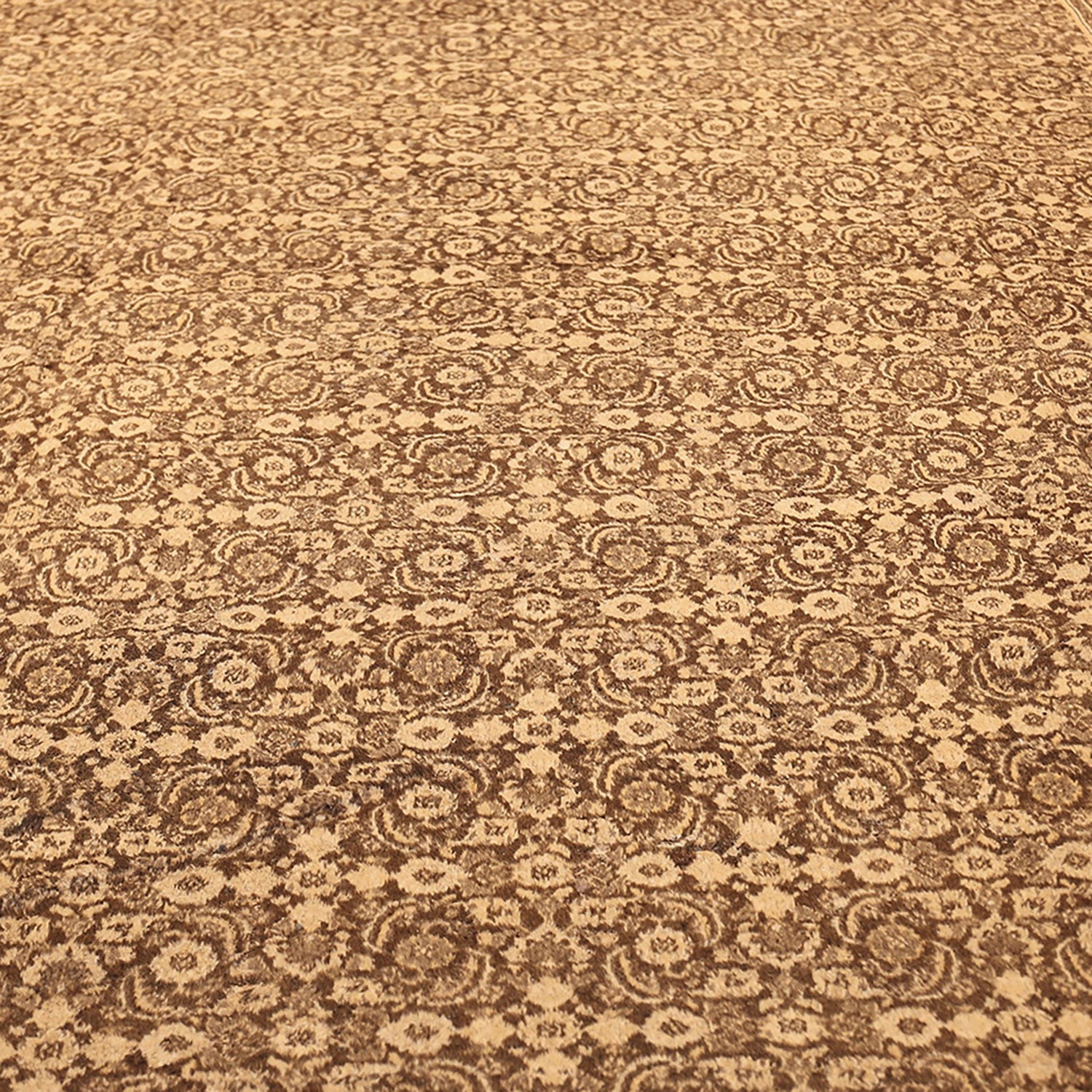 Intricate and symmetrical brown carpet with floral medallion-like designs.
