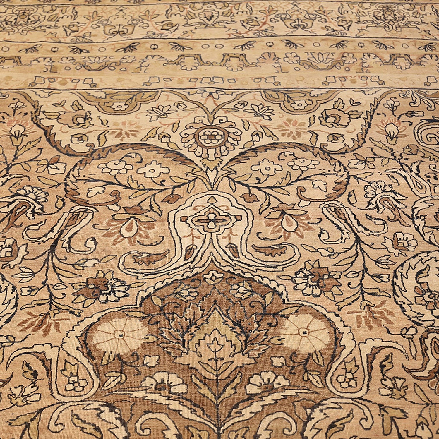 Close-up of an intricately patterned, symmetrical carpet with floral motifs.