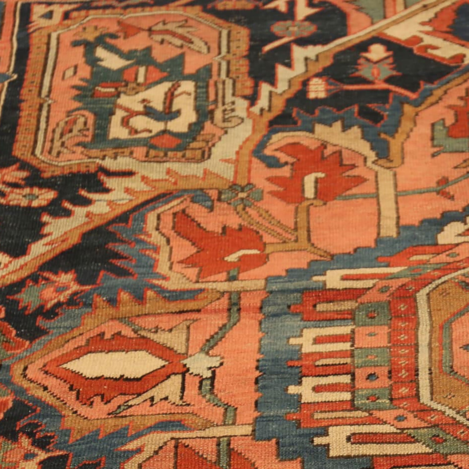 Close-up of a handwoven intricate patterned rug in vibrant colors.