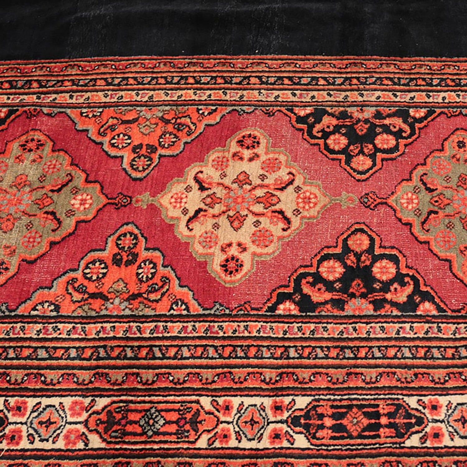 An ornate, handwoven rug with traditional design in vibrant colors.