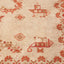 Close-up of a vintage cream carpet with red geometric floral pattern